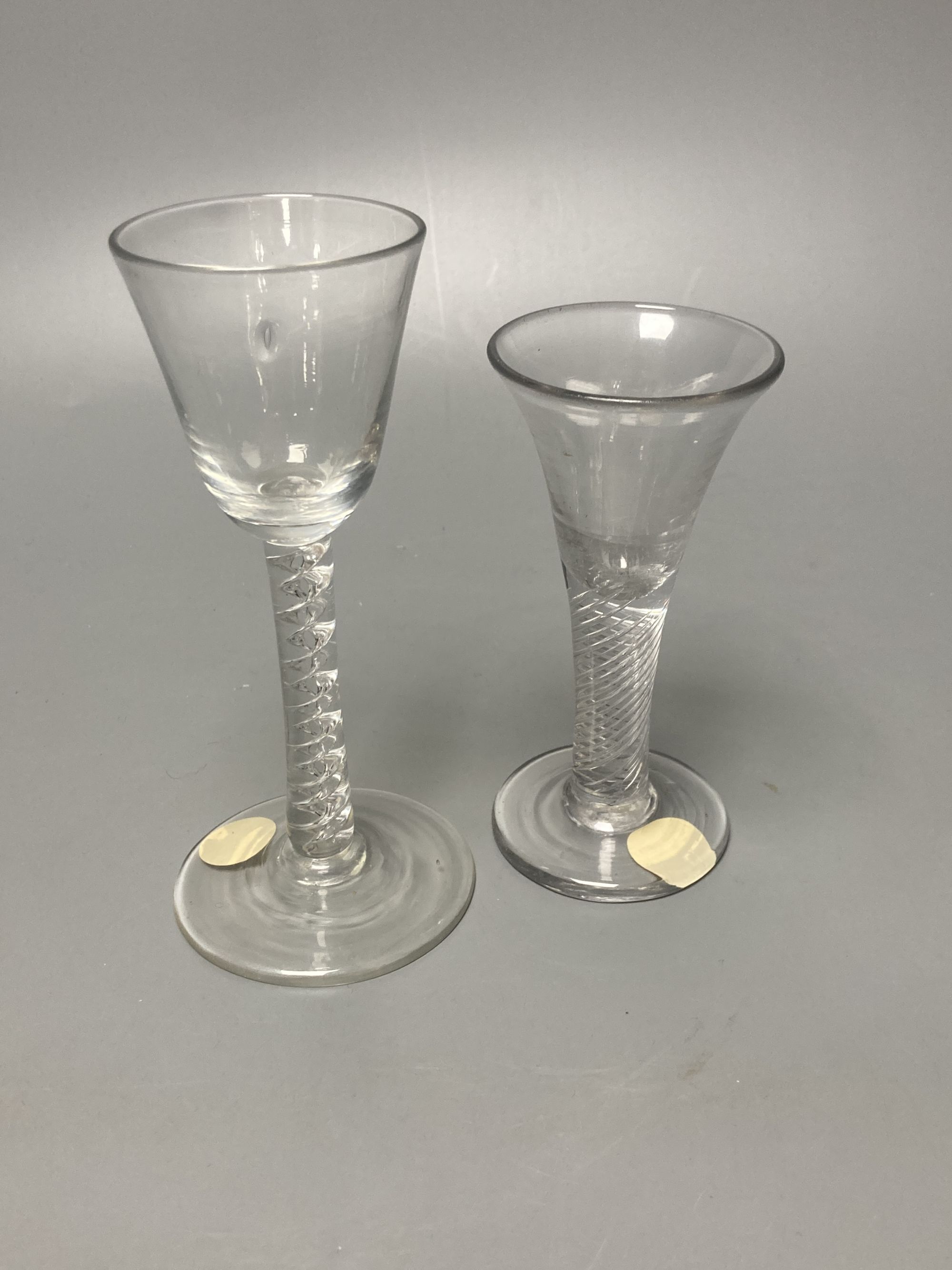 Two George II mercurial air twist stem cordial glasses, c.1750-5, with funnel and drawn trumpet bowls, 15.1cm and 12.4cm